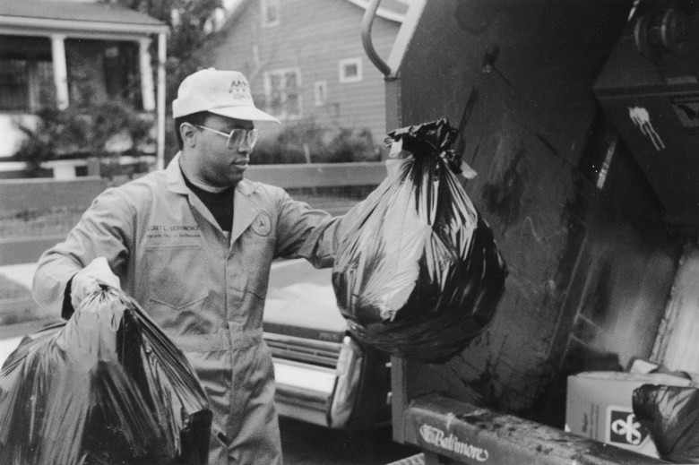 Black and white photograph. -- Baltimore, MD, APRIL 15, 1988 -- Mayor Kurt Schmoke picks up trash. Baltimore Sun staff photo by Irving H. Phillips, Jr.