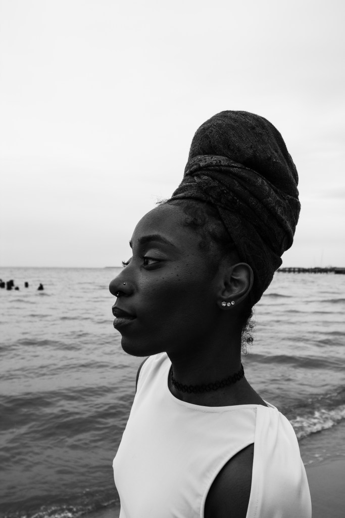Black and white photo of a person with brown skin. 