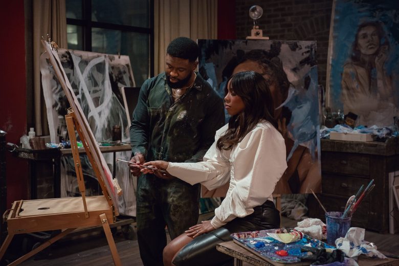 A shot from the film "Mea Culpa." A man and a woman paint a picture.