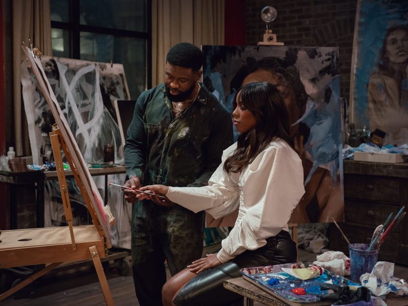 A shot from the film "Mea Culpa." A man and a woman paint a picture.