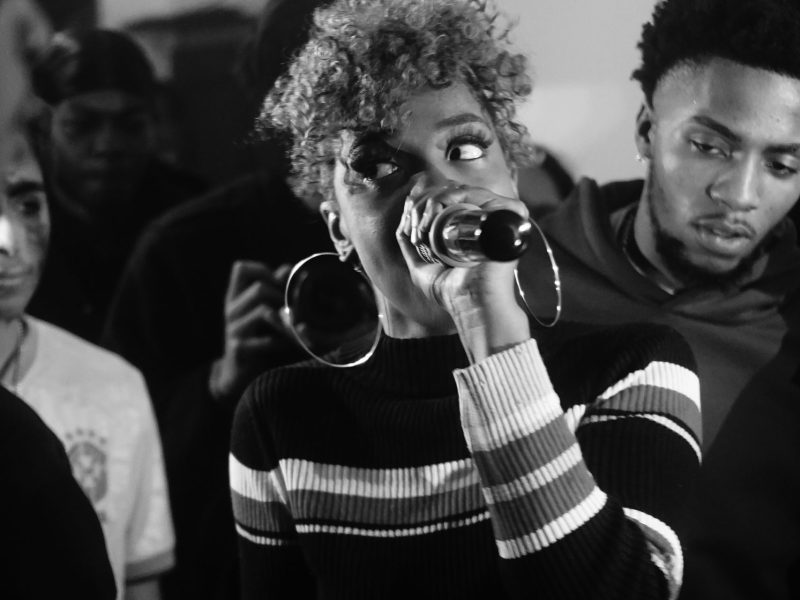 Photo of a person performing at a rap battle