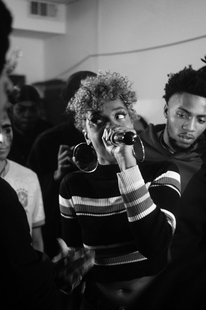 Photo of a person performing at a rap battle