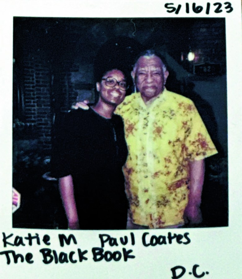 Two figures stand by side, this is a Polaroid camera, and black handwriting states " Katie M. Paul Coates, The Black Book." 
