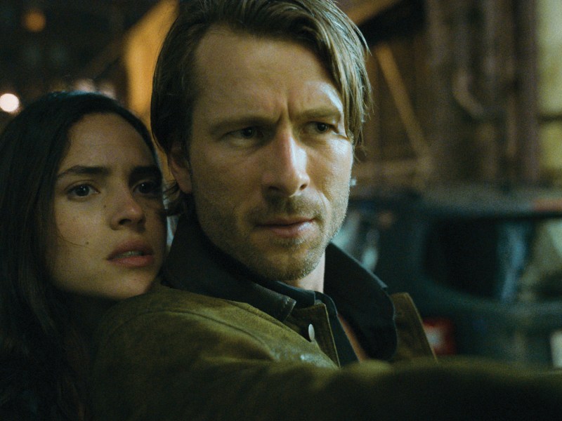 A still from a film. Two people are looking into the distance.