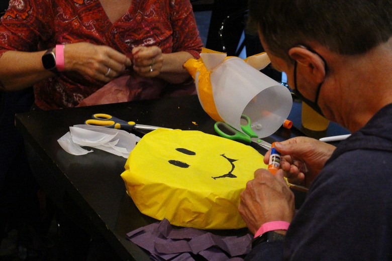 People constructing lanterns in workshop