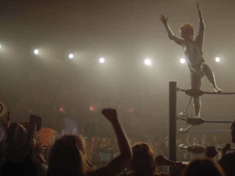 A wrestler performs in a ring.