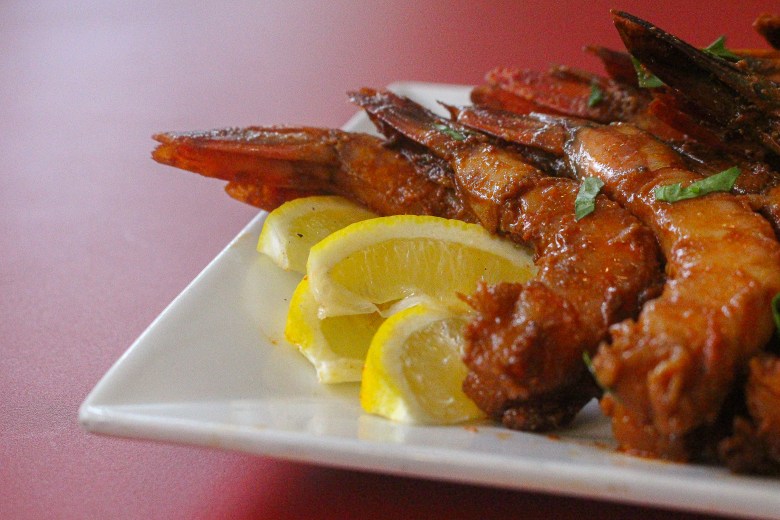 Smoked shrimp garnished with lemons on display at Neopol Savory Smokery.