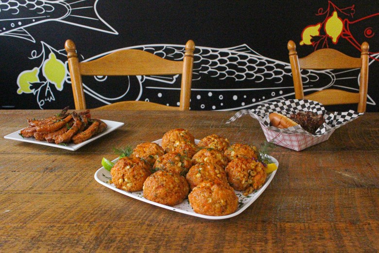 three dishes are on display on a wood tabletop.