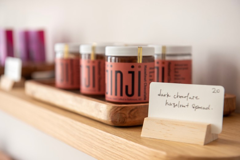 A photograph of a row of dark chocolate hazelnut spread.