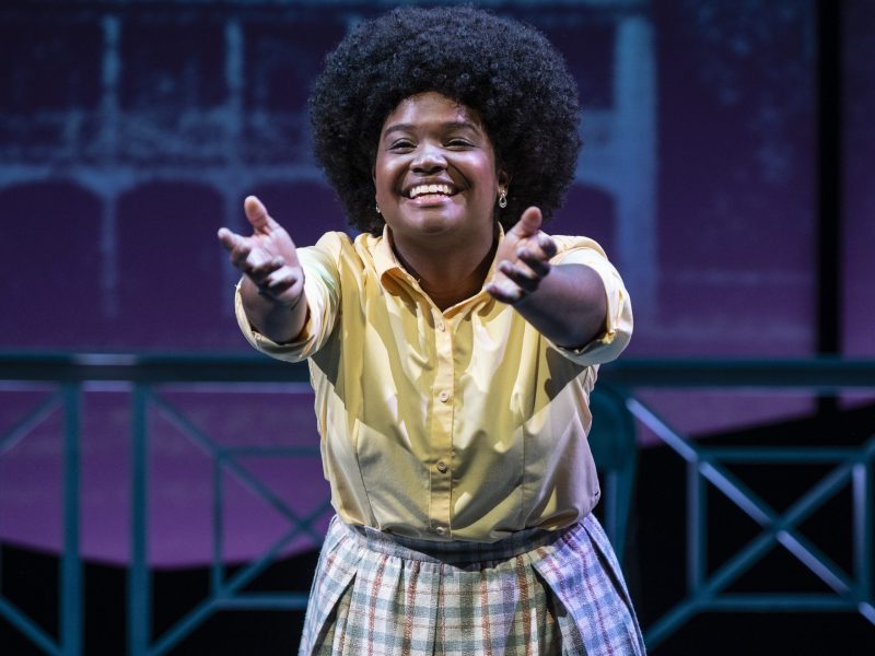 A woman acts on a stage.