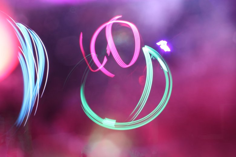 Swirls of green, pink, and blue light.