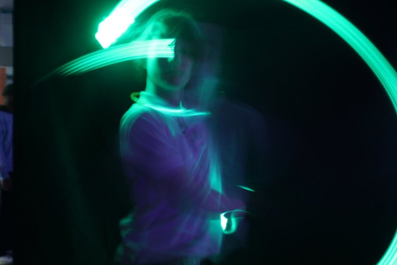 A photo of a young person surrounded by neon green light