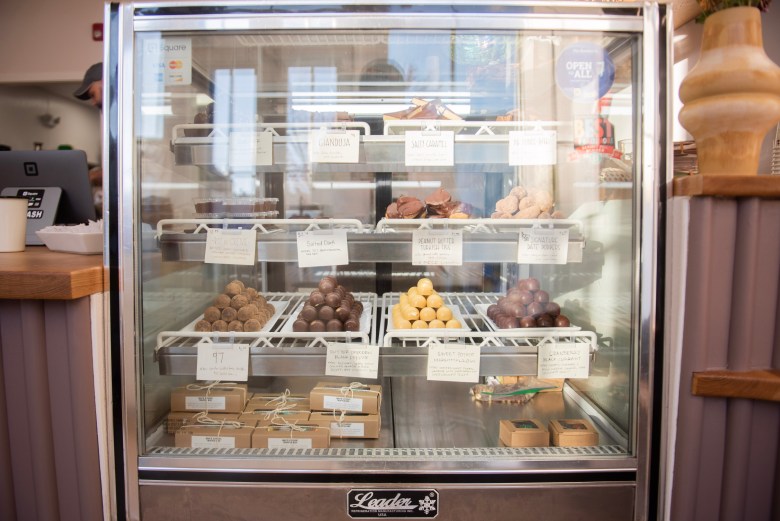 A photograph of a display case of chocolates for sale.