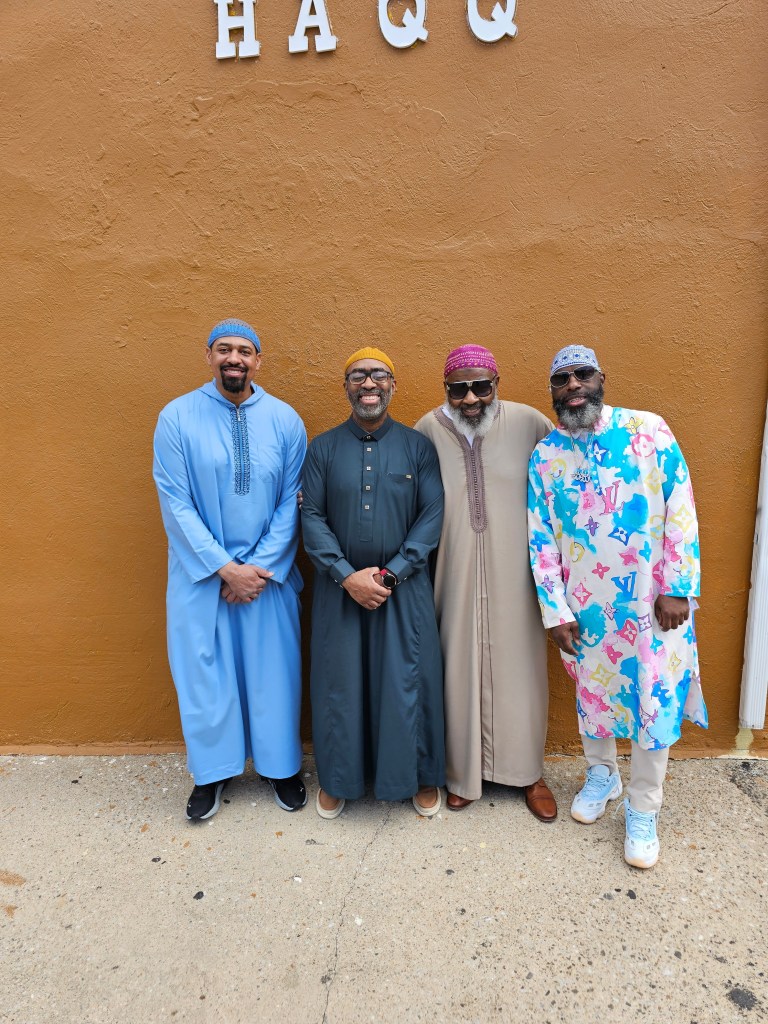 A group of men pose for a photo.