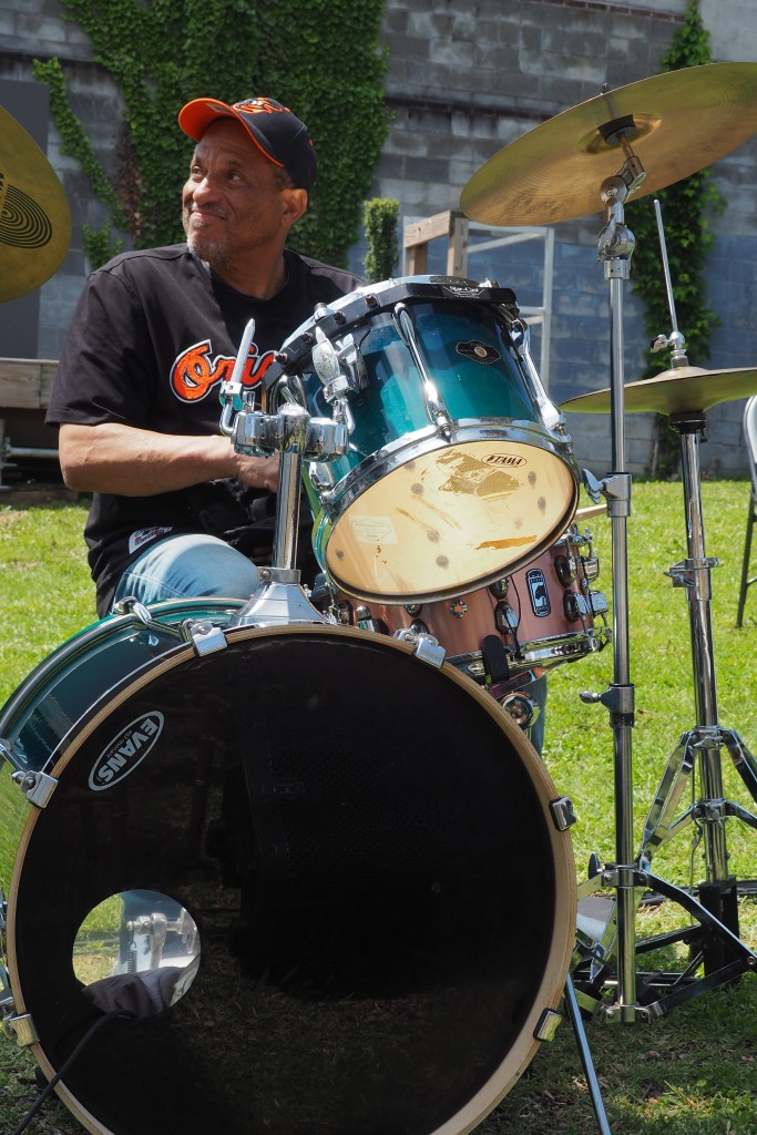 Drummer for the live music portion setting up at the opening ceremony of The Alley at The Urban Oasis.