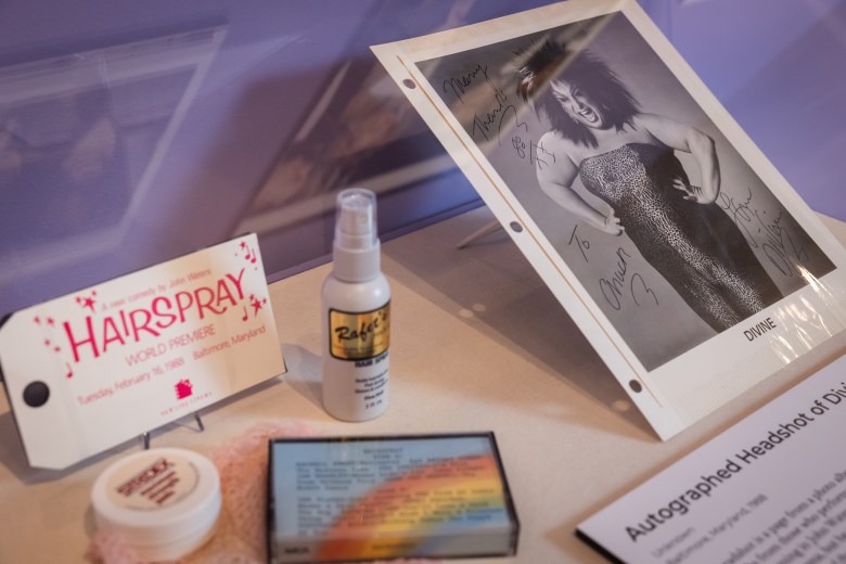 A signed portrait of Divine, as well as various memorabilia from John Waters films.