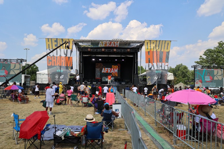 A crowd before a stage at a music festival