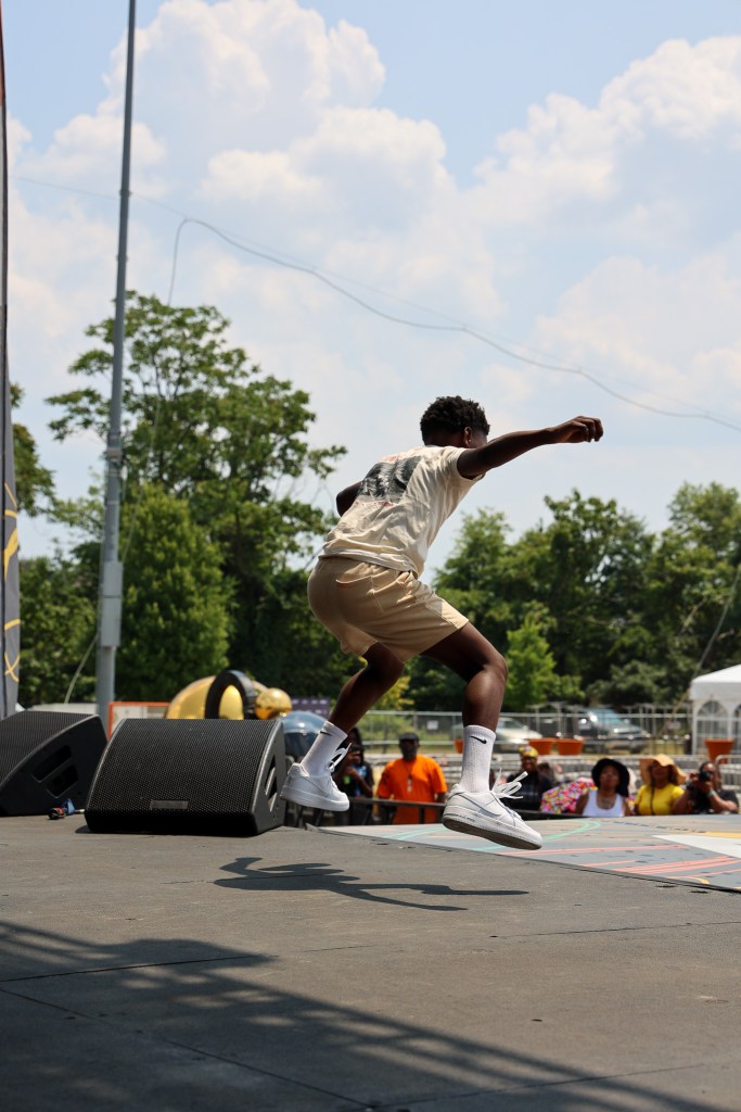 A young person dances on a stage