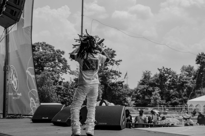 A black and white photo of a young person performing on a stage.