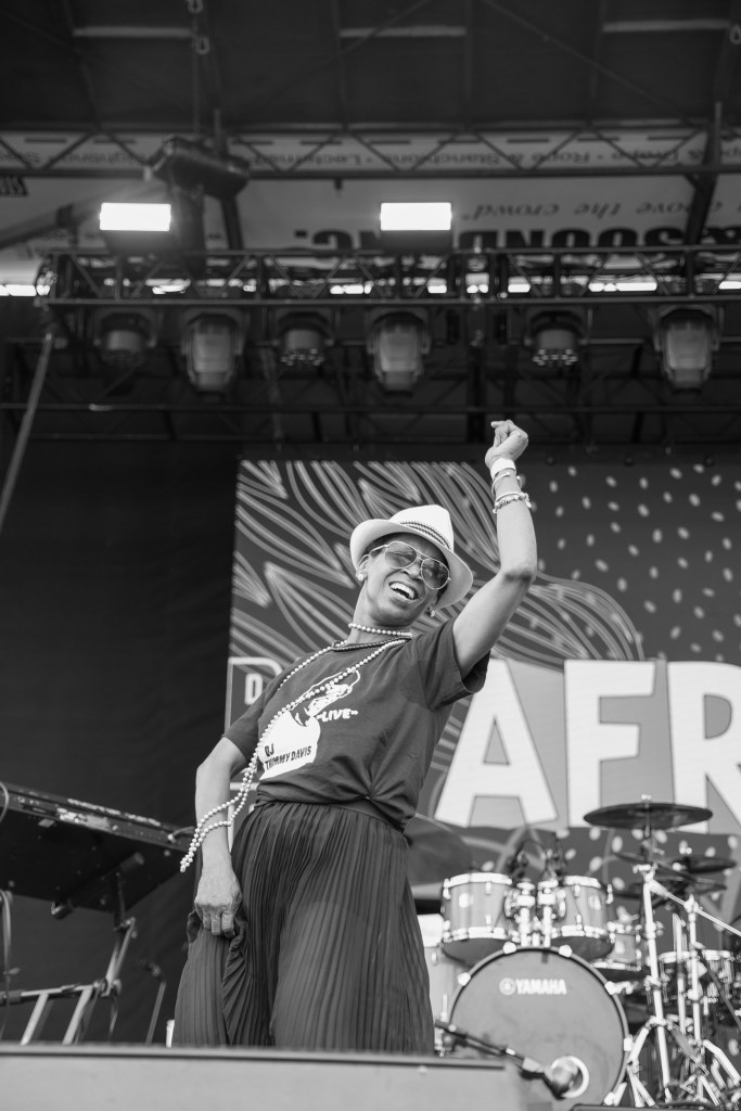A woman dances on a stage in a black and white photograph.