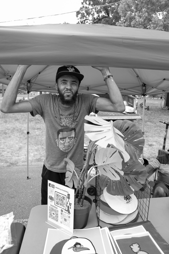 A person smiles under a tent
