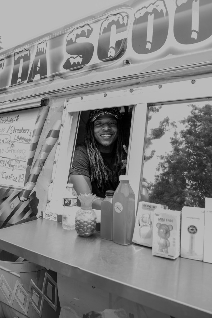 A person smiles in a food truck.