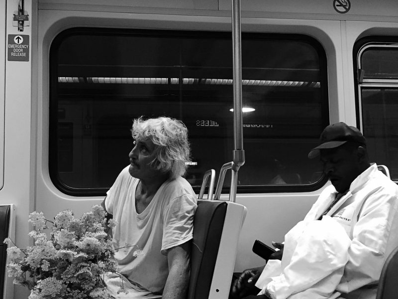 Two people on public transportation.