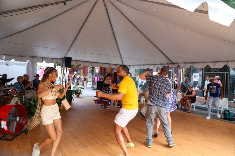 A group of people dancing in a tent