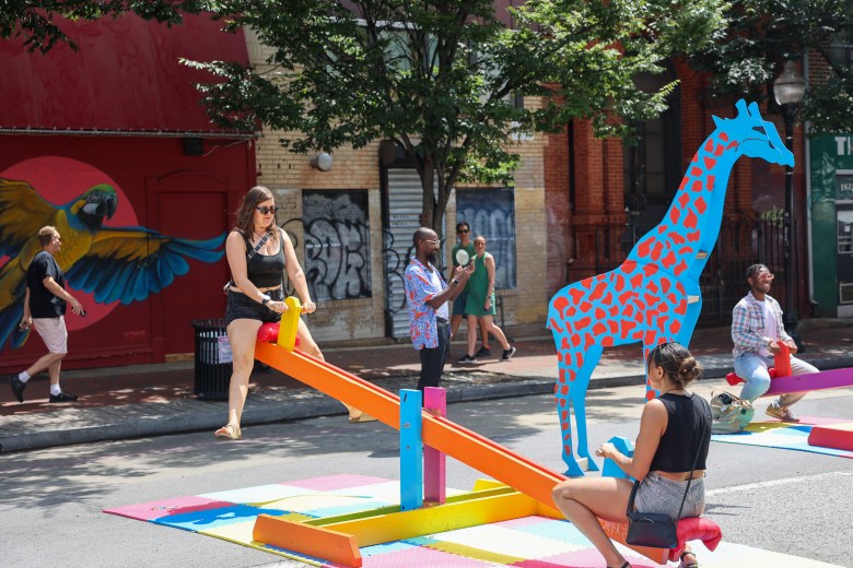 A pair enjoying a colorful see-saw.