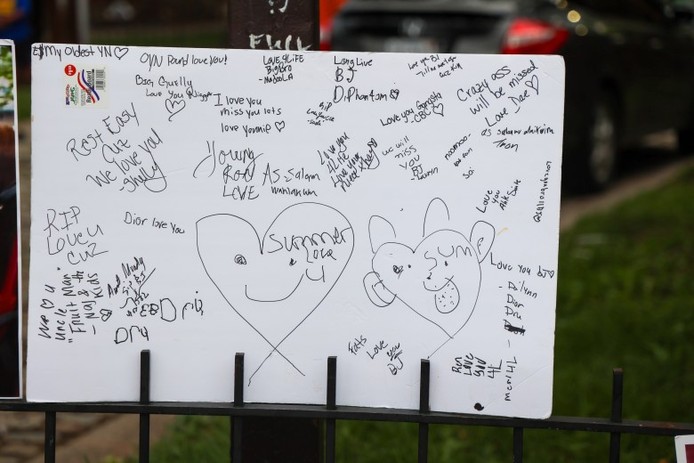A white sheet of poster board with various messages written on it.