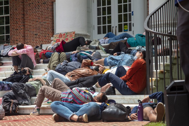This photo is a closer up shot of people lying down on the steps of Gilman Hall.