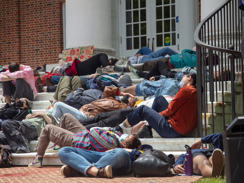 People lie on the steps of a building