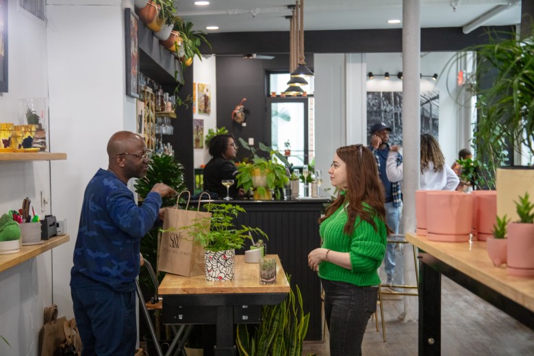 A photo of a man and woman in Stem & Vine, a store that sells plants in Baltimore City.