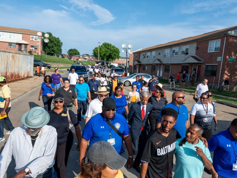 Baltimore Mayor Brandon Scott and community members at a walk held in Brooklyn on July 5, 2023.