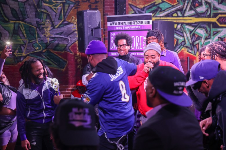 a group of people lauging and dancing at an award celebration in Baltimore