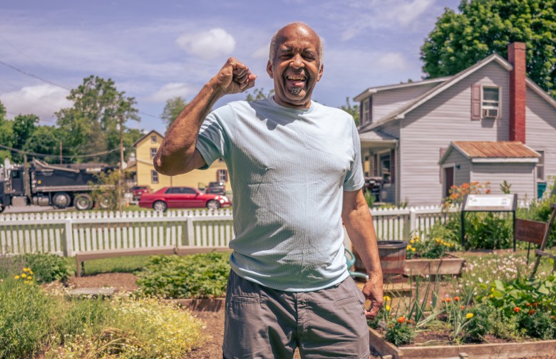 A photo of a man with brown skin posing.