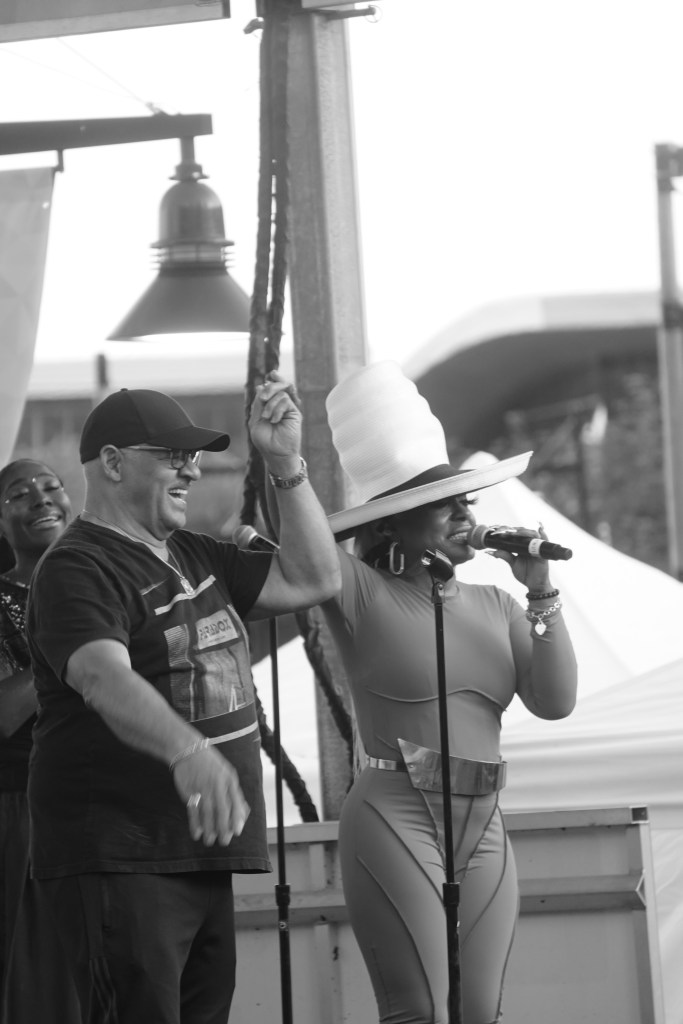 Three people on stage smiling