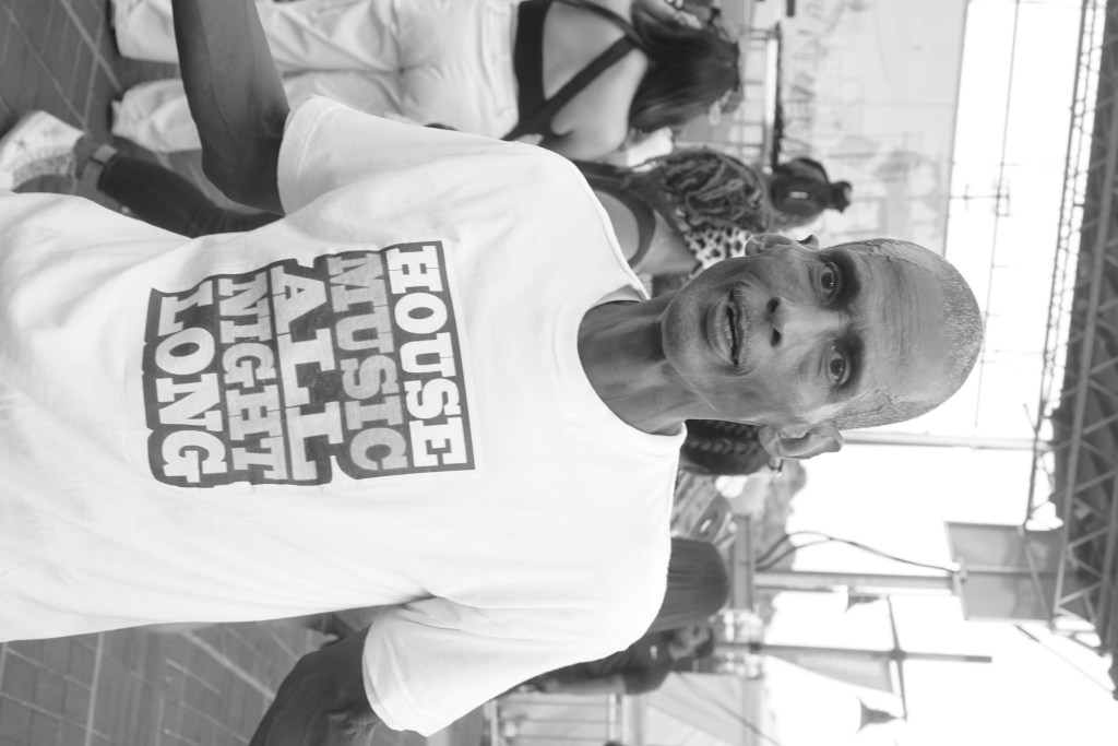 A person wears a t-shirt that reads "House Music All Night Long."
