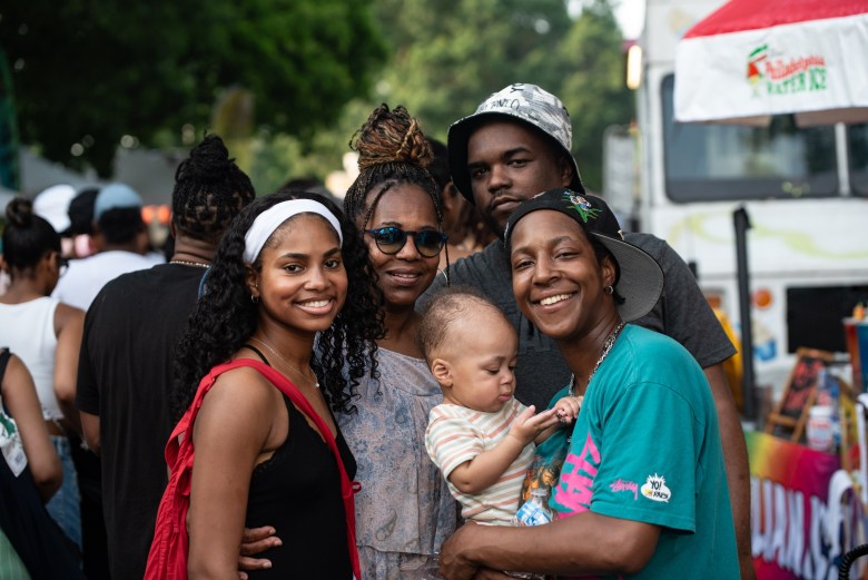 A group of people of various ages smile for the camera.