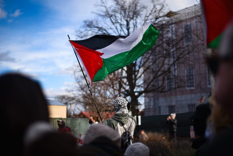 A protestor waves a Palestinian flag