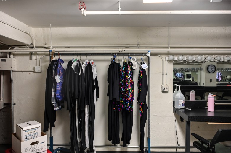 Costumes hang on a rack.