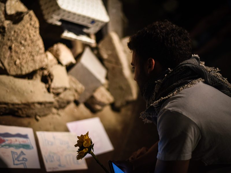 An person views a work of art up closely.