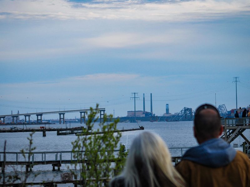 People observe the wreckage of the Francis Scott Key Bridge in Baltimore.