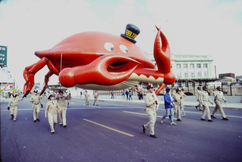  A giant inflatable crab wearing a top hat is pulled down North Charles Street by Penn Station in 1982. Image courtesy of the Baltimore Office of Promotion & Arts.