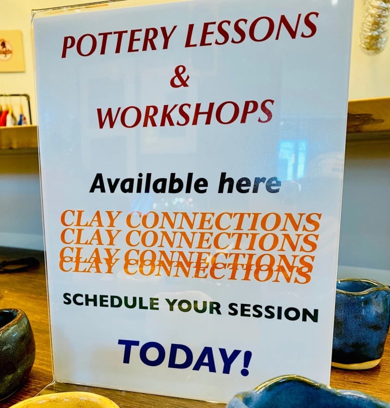 A photograph of a sign announcing a clay workshop. 