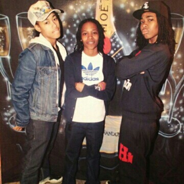 Three young adults pose for a picture.