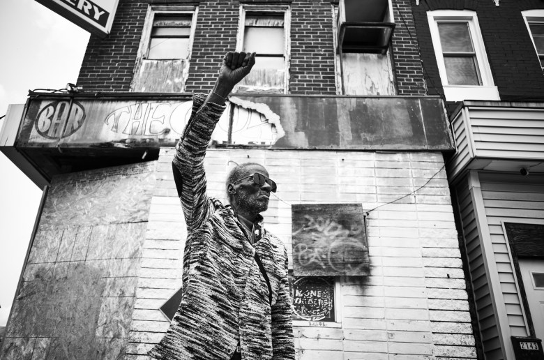 A man raises his fist in salute.