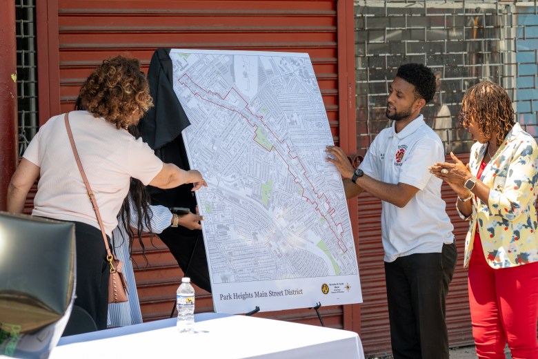 Baltimore Mayor Brandon Scott shows a map.
