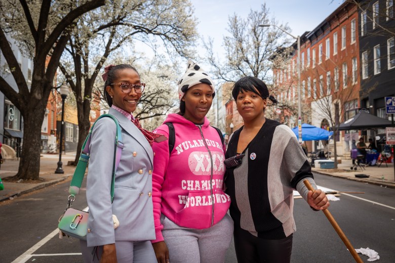 A group of three people pose for a photo.