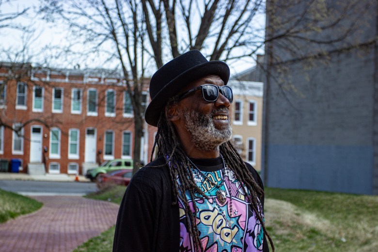 A photo of Duane "Shorty" Davis. He is a Black man and he wears a black jacket with a brightly colored shirt underneath.
